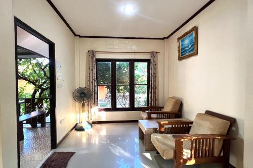 a living room with a couch and a table at Saithong Resort in Udon Thani