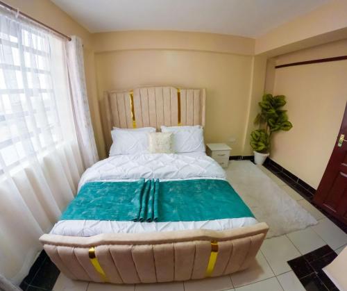 a bedroom with a large bed with a large window at Brightstay furnished apartments in Nairobi