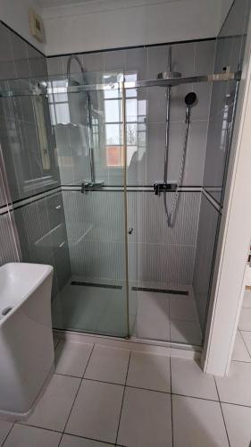 a shower with a glass door in a bathroom at Schloss Krugsdorf Golf & Hotel in Krugsdorf
