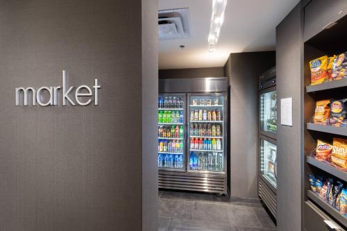 a grocery store aisle with a refrigerator and drinks at Courtyard by Marriott Bowie in Bowie