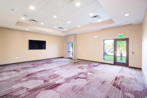 an empty room with a flat screen tv and a large floor at Courtyard by Marriott Bowie in Bowie