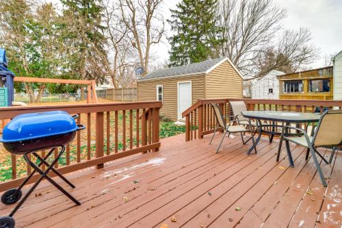a deck with a grill and a table and chairs at Walk to Adrian College Family Home in Michigan in Adrian