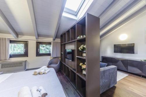 a room with a bed and a couch and a tv at Luxury Apartment Venice in Venice