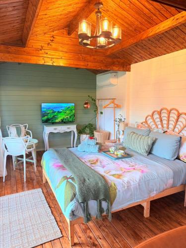 a bedroom with a large bed with a wooden ceiling at Blissful Wooden Haven - complete place is yours 5 min drive or train from parramatta in Wentworthville