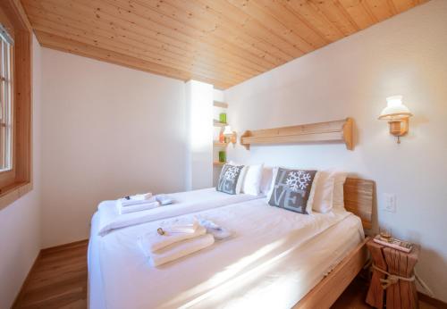 a bedroom with a bed with towels on it at Chalet Sterndolde Apt 1 in Wengen