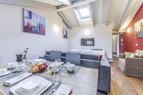 a dining room and living room with a table and chairs at Luxury Apartment Venice in Venice