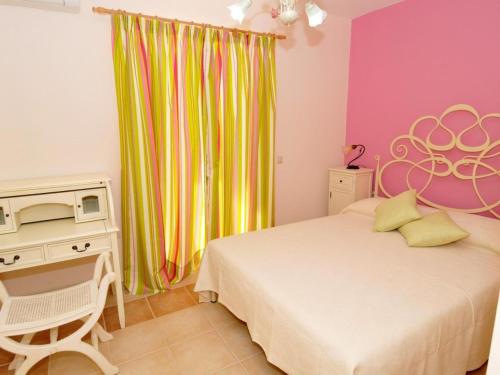 a bedroom with a bed and a desk with a microwave at Sami Beach Villas Fedra in Sami