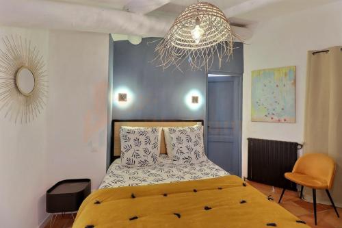 a bedroom with a large bed and a chandelier at The Provencal Escape - Swimming Pool & Nature in Trets