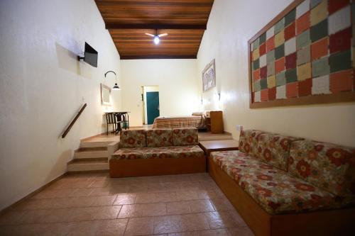a living room with two couches and a staircase at Hotel Berro D`Agua Eco Resort in Avaré
