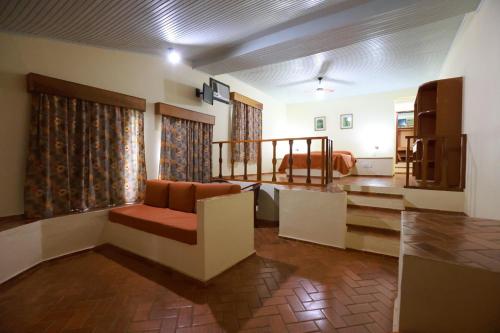 a living room with a couch and a television at Hotel Berro D`Agua Eco Resort in Avaré