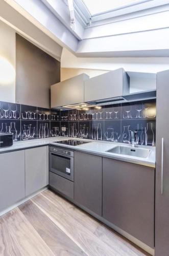 a large kitchen with white cabinets and a sink at Luxury Apartment Venice in Venice