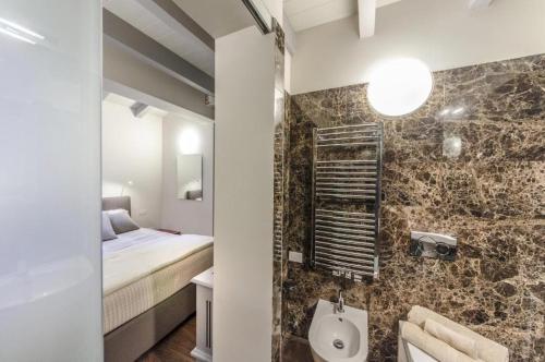 a bathroom with a bed and a sink in a room at Luxury Apartment Venice in Venice