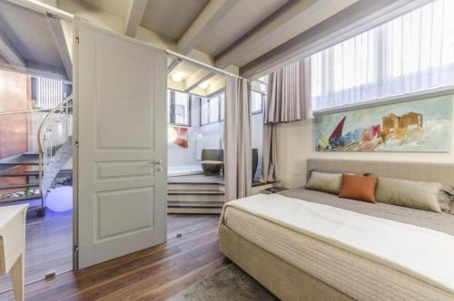 a bedroom with a bed and a large window at Luxury Apartment Venice in Venice