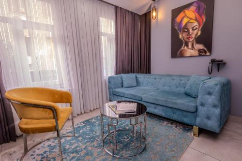 a living room with a blue couch and a table at Ruby Hotel in Istanbul