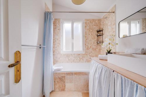 une salle de bain avec une baignoire et un lavabo dans l'établissement L'Odéia - Chamant appt en plein coeur de Bordeaux, à Bordeaux