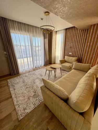 a living room with a couch and a table at Henry Resort & Spa in Golem