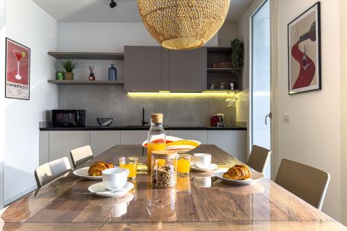 a dining room table with food and a bottle of orange juice at Residence Canova in Spinea