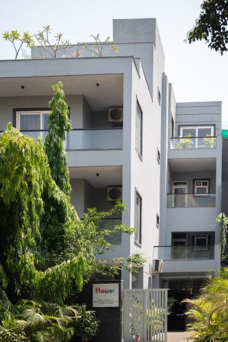 an apartment building with a tree in front of it at Housr Phase 1 Arjun Marg & Golf Course Road in Gurgaon