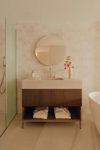 a bathroom with a sink and a mirror at Aethos Mallorca in Paguera