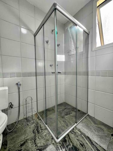 a glass shower in a bathroom with a toilet at Renoir - Av Barão Homem de Melo nº 4520 - pegar nº do flat no chat após reserva in Belo Horizonte