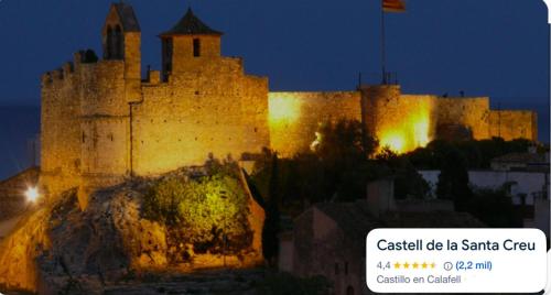 a large castle is lit up at night at Apartaments Kandy 2 in Calafell