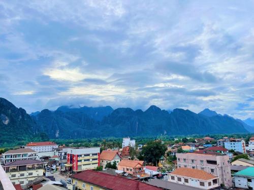 a view of a city with mountains in the background at Vangvieng Sisavang Hotel in Vang Vieng