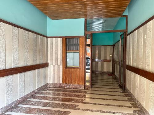 a hallway of a building with a wooden door at Xcross Suites Garbatella in Garbatella