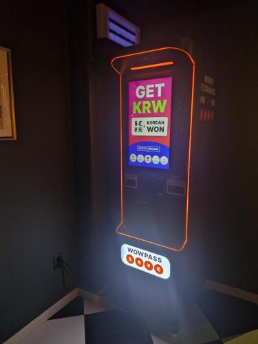 a sign for a kiwi machine in a room at Bluedot Poshtel in Seoul