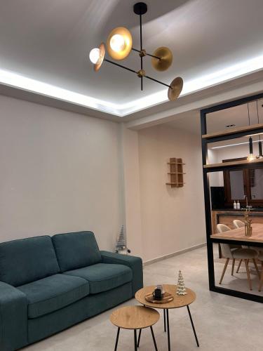 a living room with a blue couch and a table at Abete Luxury Apartments in Metsovo