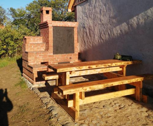 a wooden bench sitting next to a brick wall at 200 Years of History in Woldenberg Neumark