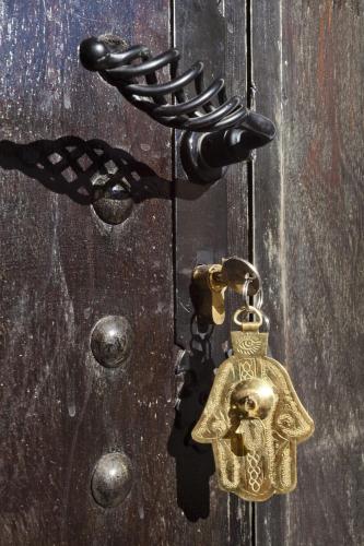 a bronze door latch with a skull on it at Riad Palais Bahia Fes in Fès