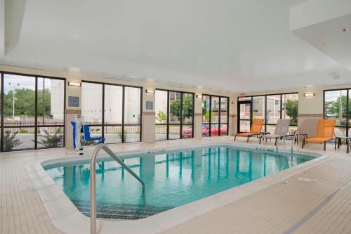 a large swimming pool in a building with windows at Courtyard by Marriott Niagara Falls, USA in Niagara Falls