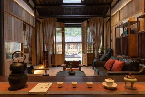 a living room with a couch and a table at the Wild Luxury Holiday Inn in Xingping