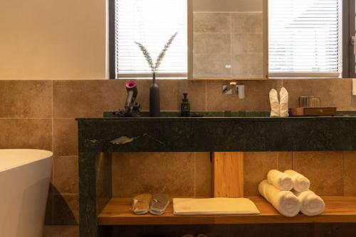 a bathroom with a counter with shoes on a shelf at the Wild Luxury Holiday Inn in Xingping