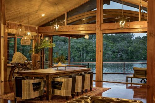 a large living room with a table and a large window at Little Fish - Luxury Retreat in Yallingup in Yallingup