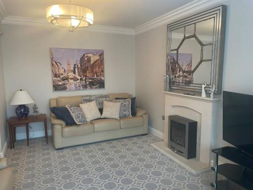 a living room with a couch and a fireplace at Beautiful town house in the heart of Knutsford in Knutsford