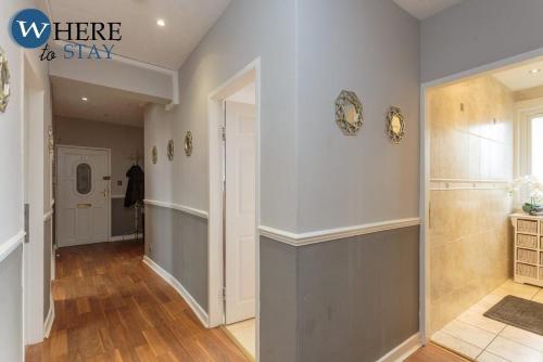 a hallway of a home with white walls and wood floors at Stylish 3 Bedroom Apartment, Edinburgh in Edinburgh