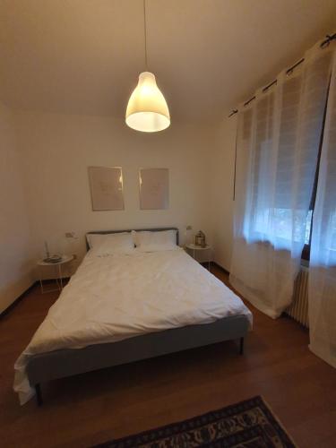 a bedroom with a large bed with a light at La Corte Industriale in Crespano del Grappa