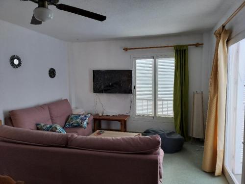 a living room with a couch and a window at Apartamento con piscina en Garrucha, Vera in Garrucha