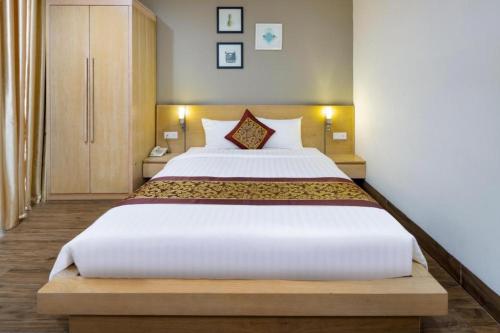 Postel nebo postele na pokoji v ubytování Gibson Hotel Nha Trang