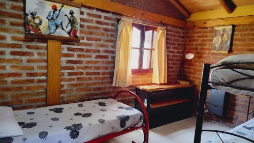 En eller flere senge i et værelse på Bosque Nativo