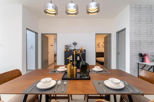 a dining room with a wooden table and chairs at Serene Minimalist Family Retreat 2-7pax &Sunrise View in Brinchang