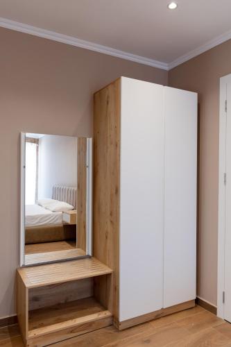 a bedroom with a mirror and a bed at Lider Hotel in Ksamil