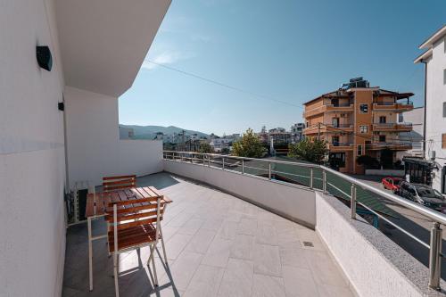 a balcony with two chairs and a view of a city at Lider Hotel in Ksamil