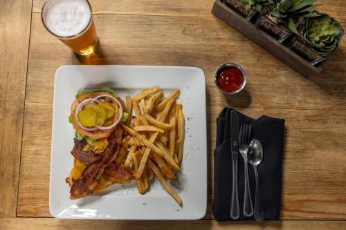 a plate of food with a sandwich and french fries at Hotel Preston Nashville Airport in Nashville