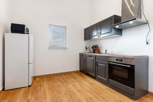 a kitchen with a stainless steel appliances and a refrigerator at White House Apartments in Kappel-Grafenhausen