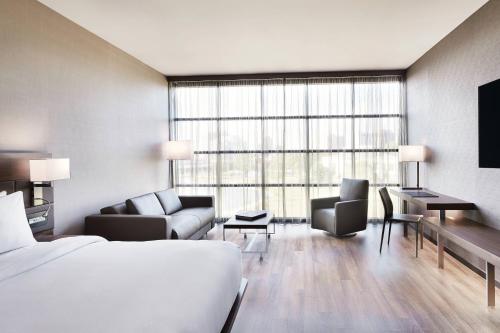 a hotel room with a bed and a large window at AC Hotel by Marriott Huntsville Downtown in Huntsville