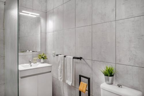 a white bathroom with a sink and a toilet at Canaan Boutique Casa do Monte by Get Your Stay in Boliqueime