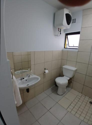 a bathroom with a toilet and a sink at Grace Villas 25 in East London