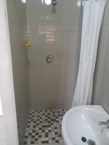 a bathroom with a shower and a sink at Park Q Residence in Pimville